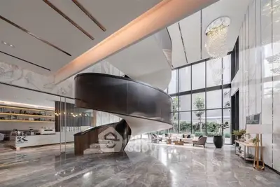 Luxurious modern lobby with grand spiral staircase and elegant chandelier