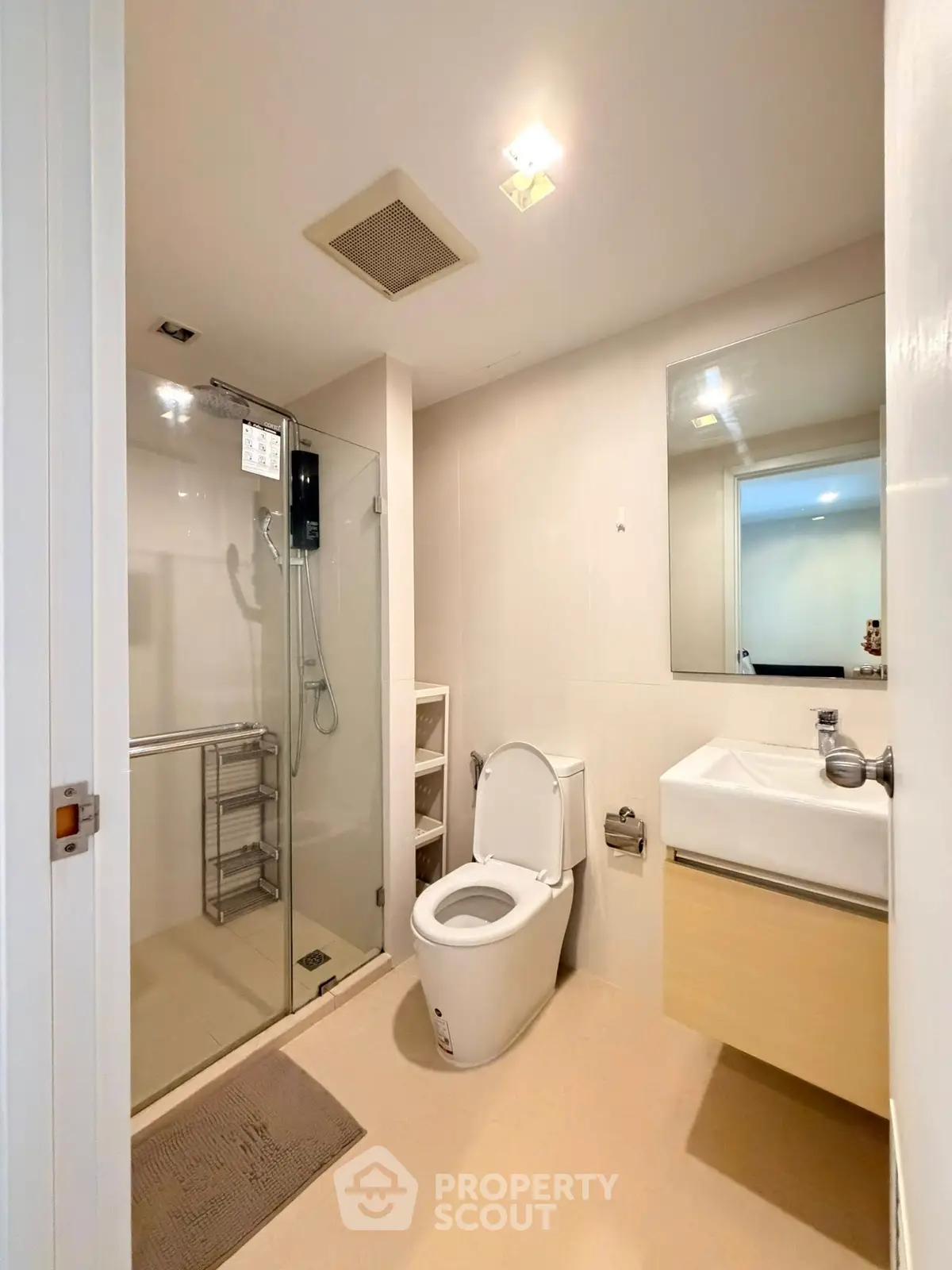 Modern bathroom with glass shower, sleek fixtures, and neutral tones for a clean, contemporary look.