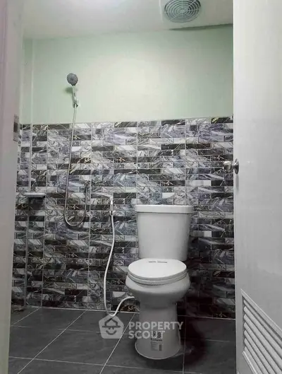 Modern bathroom with stylish tile design and shower setup