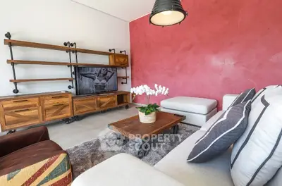 Stylish living room with modern industrial furniture and vibrant red accent wall