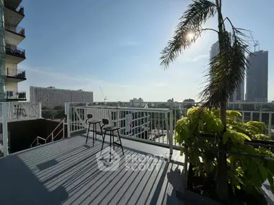 Stunning balcony view with cityscape and ocean horizon, perfect for relaxation.