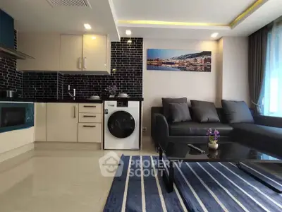 Modern living room with sleek kitchen and stylish decor