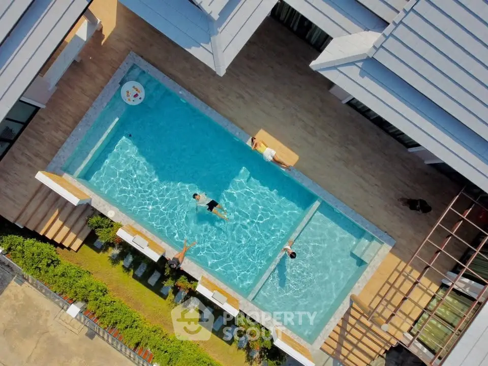 Stunning aerial view of modern residential pool area with sleek design and inviting atmosphere.