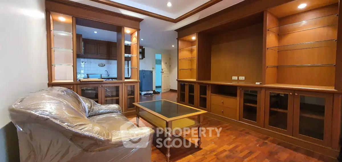 Spacious living room with elegant wooden cabinetry and cozy seating area