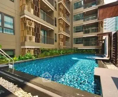 Luxurious residential building with a sparkling outdoor pool and modern design.