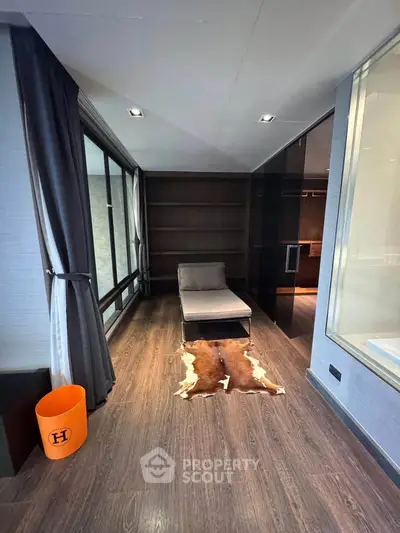 Luxurious modern living space with sleek design and floor-to-ceiling windows.