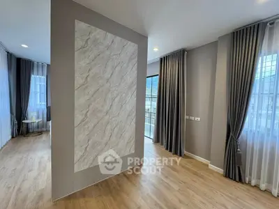 Spacious modern living room with elegant curtains and wooden flooring