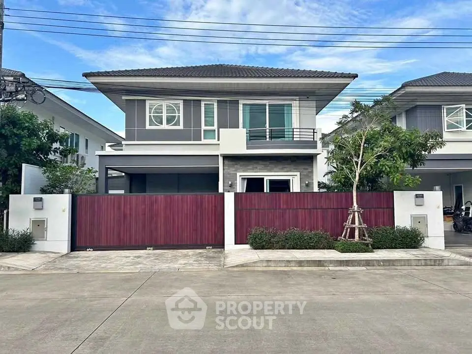 Modern two-story house with stylish facade and spacious driveway in suburban neighborhood.