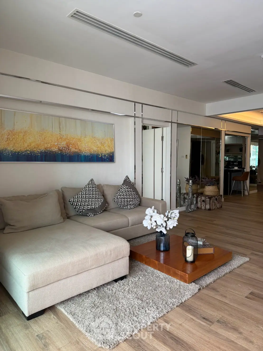 Spacious living room with modern decor and cozy seating area, perfect for relaxation and entertaining.