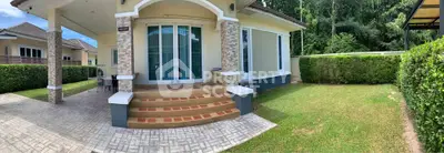 Charming single-story home with spacious front yard and elegant entrance, perfect for family living.