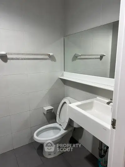 Modern minimalist bathroom with sleek fixtures and neutral tiles
