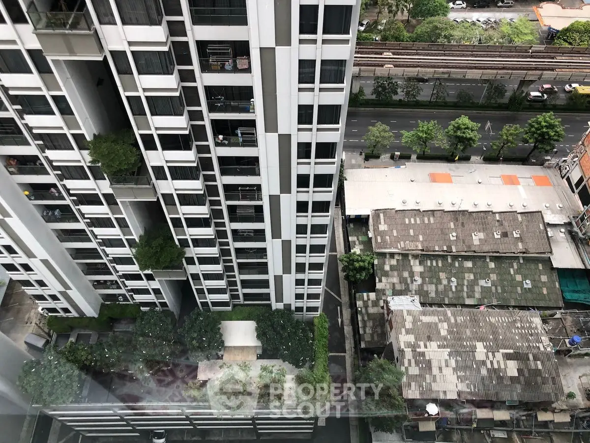High-rise building with lush garden and city view from above
