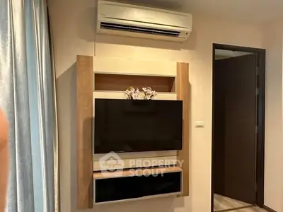 Modern living room with wall-mounted TV and air conditioning unit.