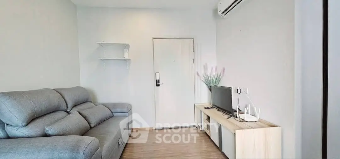 Modern living room with sleek furniture and air conditioning, perfect for comfortable living.