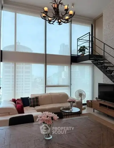 Spacious modern living room with high ceilings and large windows offering city views.