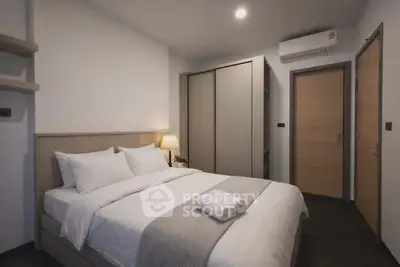 Modern bedroom with cozy bed, sleek wardrobe, and ambient lighting in a stylish apartment.