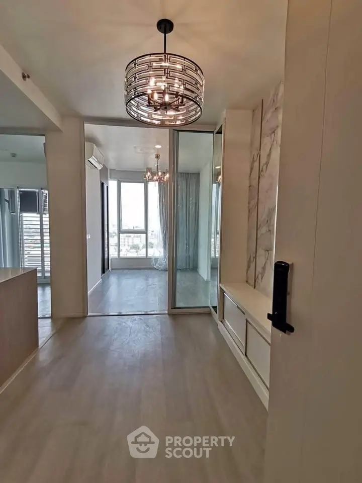 Modern apartment interior with elegant lighting and large windows offering a stunning view.
