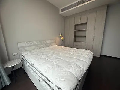 Spacious modern bedroom with stylish built-in wardrobe and cozy lighting