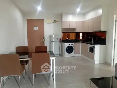 Modern kitchen with dining area and appliances in a stylish apartment.
