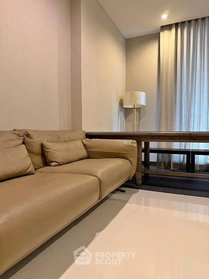 Modern living room with beige leather sofa and elegant floor lamp