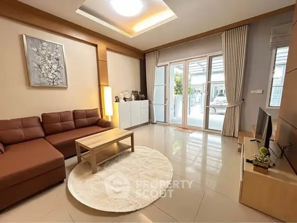 Spacious living room with modern decor and large windows for natural light.