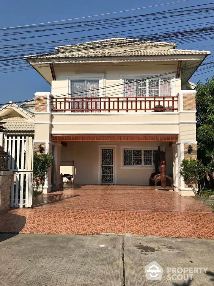 Charming two-story house with spacious driveway and balcony, perfect for family living.