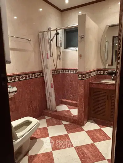 Elegant bathroom with red marble tiles and modern fixtures