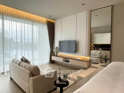 Luxurious modern living room with elegant decor and large windows offering natural light.
