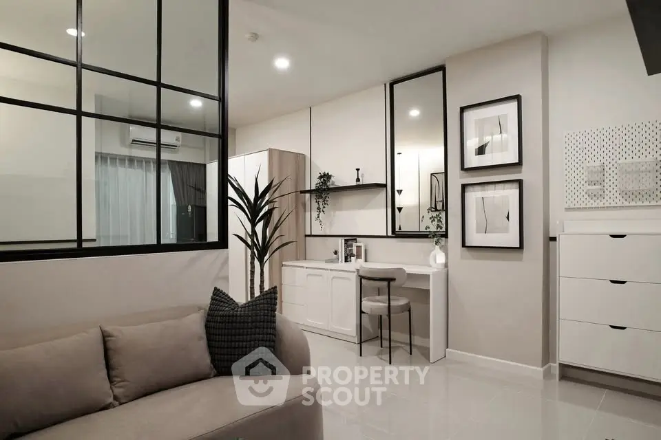 Modern living room with stylish decor and open layout, featuring a cozy sofa and elegant wall art.