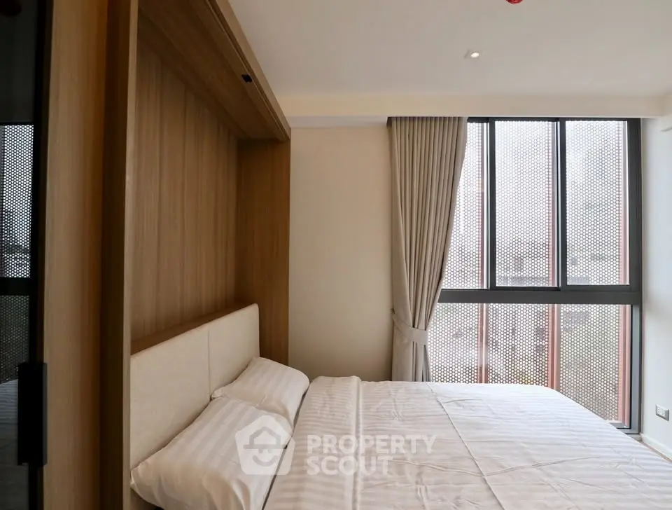 Modern bedroom with large windows and stylish wooden paneling