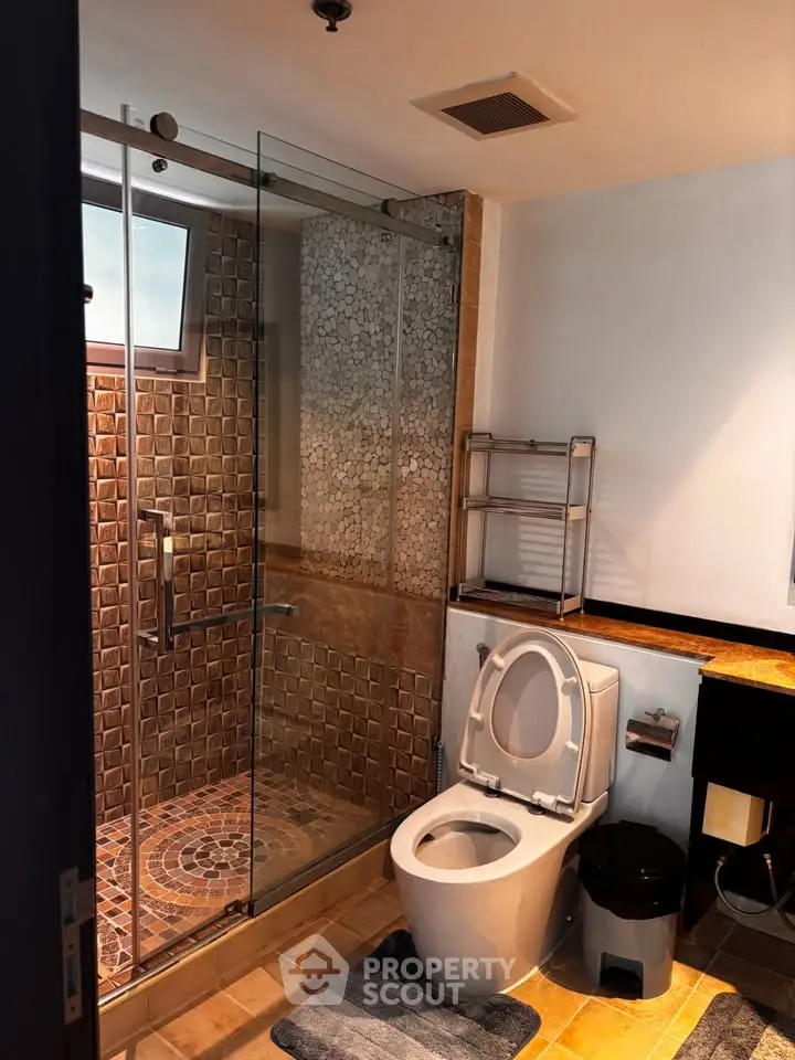 Modern bathroom with glass shower and stylish tile design