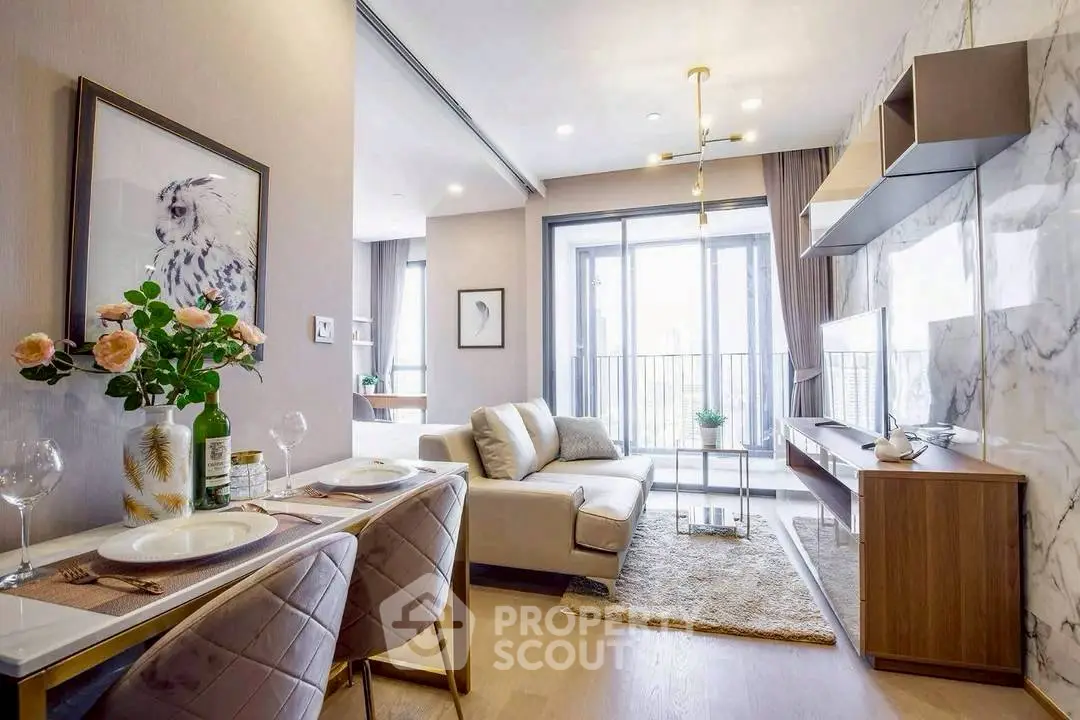 Modern living room with elegant decor and large windows leading to a balcony.