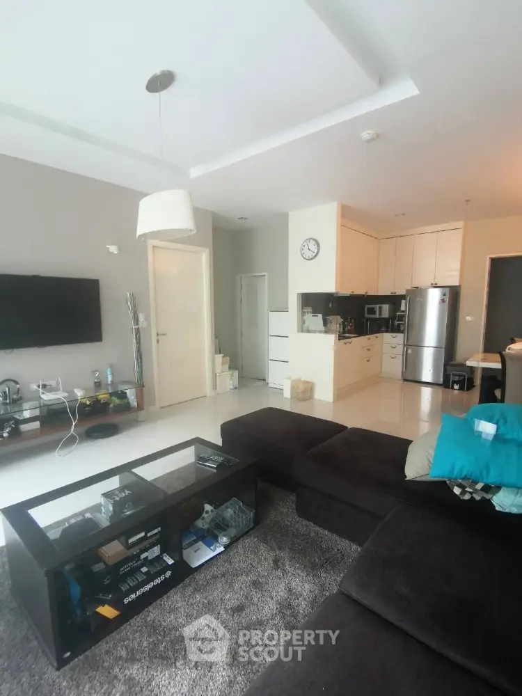 Spacious modern living room with open kitchen and sleek furnishings