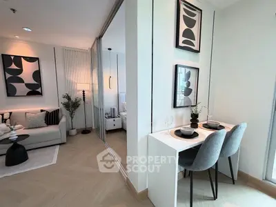 Modern living room with stylish decor and dining area in a contemporary apartment.