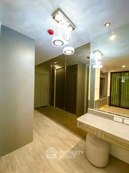 Modern hallway with mirrored wall and stylish lighting in luxury apartment