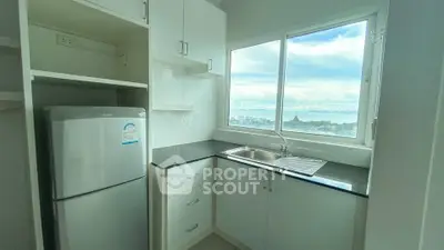 Modern kitchen with sleek cabinets and stunning city view from window