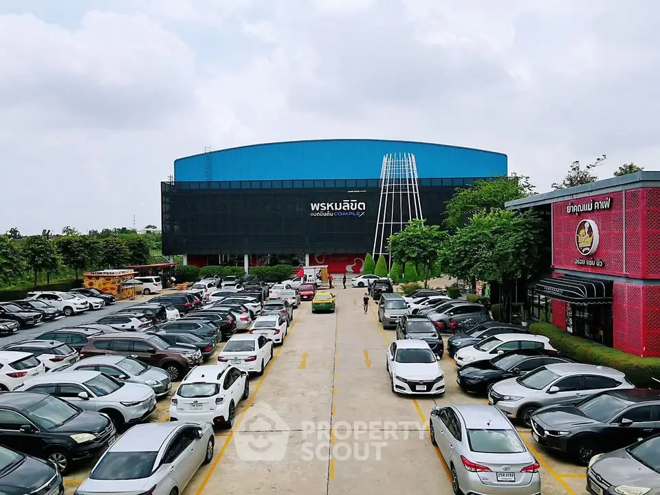 Spacious parking lot in front of a modern commercial building with ample parking space.