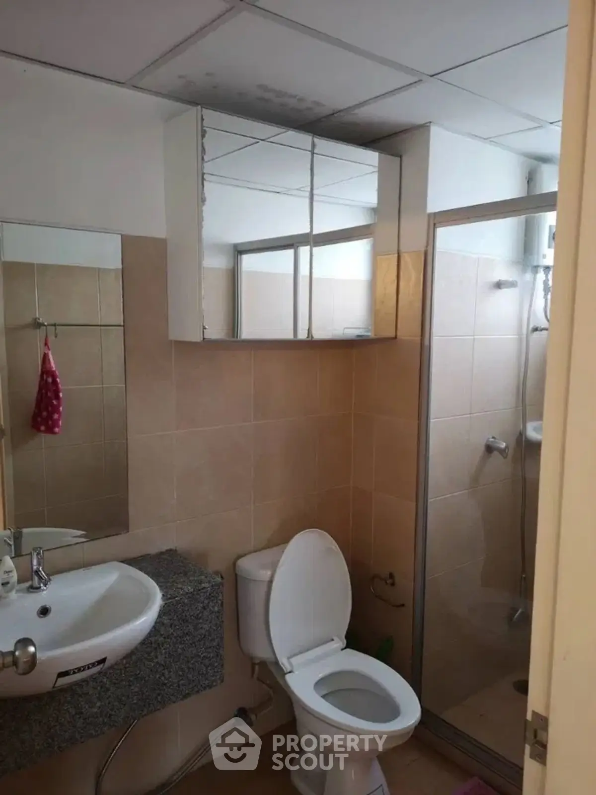 Cozy bathroom with shower and modern fixtures, ideal for compact living spaces.