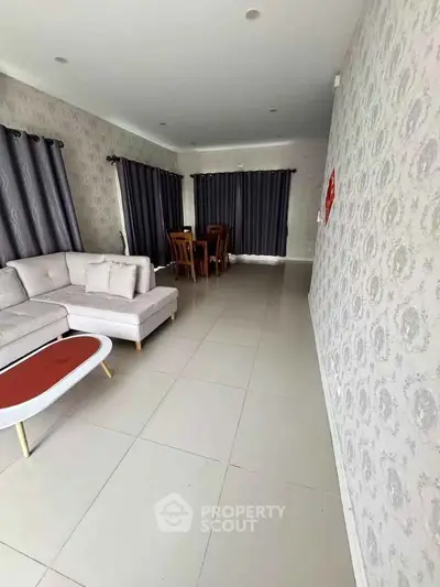 Spacious living room with elegant decor and dining area, featuring modern furniture and stylish curtains.