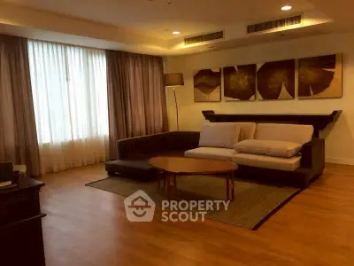 Spacious living room with modern decor and natural lighting