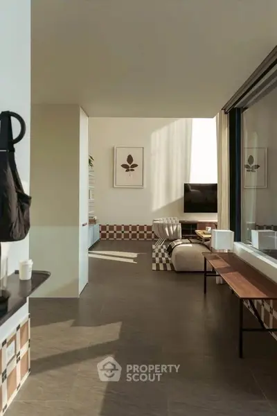 Modern living room with stylish decor and large windows offering natural light