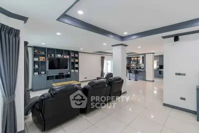 Spacious modern living room with leather seating and open kitchen layout