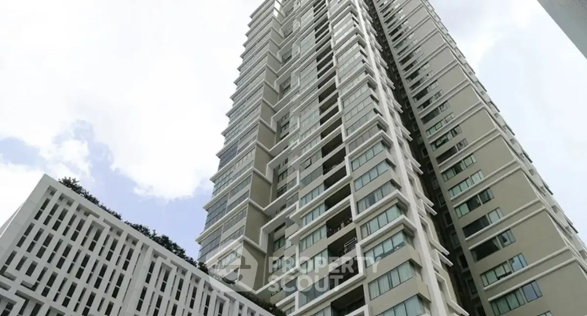 Modern high-rise building with sleek architectural design and large windows.