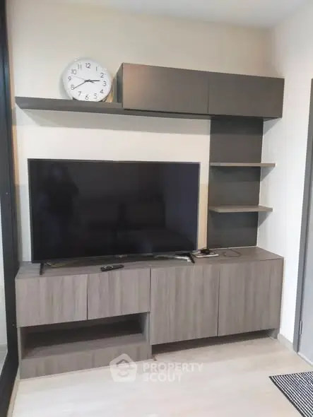 Modern living room with sleek TV unit and wall shelves