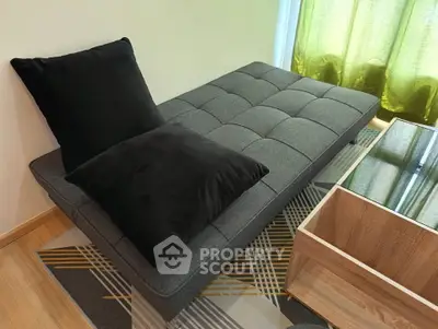 Modern living room with stylish gray sofa and wooden coffee table