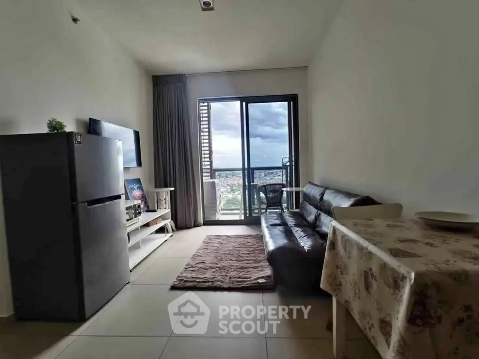 Modern living room with balcony view, sleek furniture, and natural light.