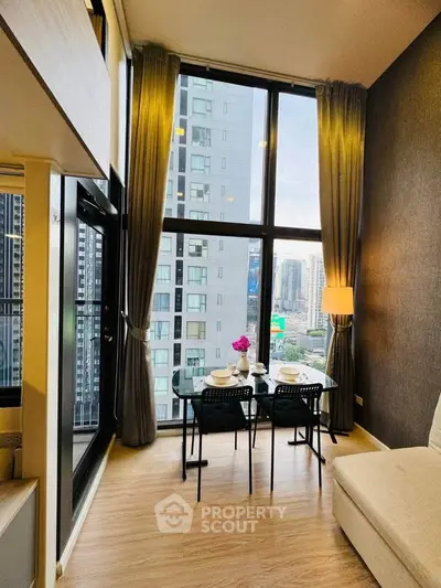 Modern high-rise apartment with floor-to-ceiling windows and city view, featuring a cozy dining area.