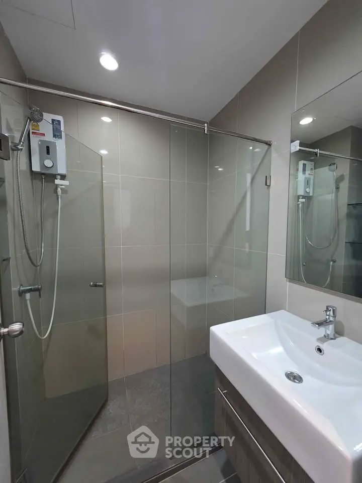 Modern bathroom with glass shower and sleek sink design