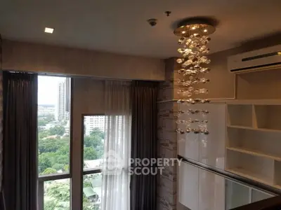 Luxurious high-rise apartment with modern chandelier and panoramic city view.