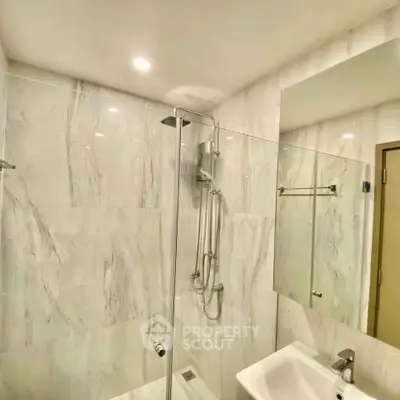 Modern bathroom with sleek shower and elegant marble tiles